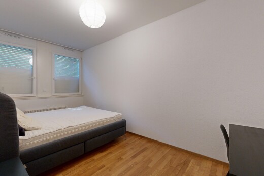 room / bedroom with light wood finished floors and radiator