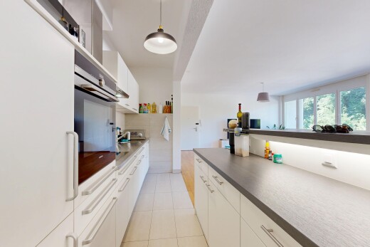 kitchen featuring white cabinetry, white refrigerator, decorative light fixtures, stainless steel oven, and dark countertops