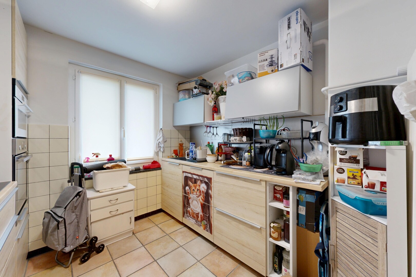 kitchen with light countertops, light tile patterned floors, and open shelves