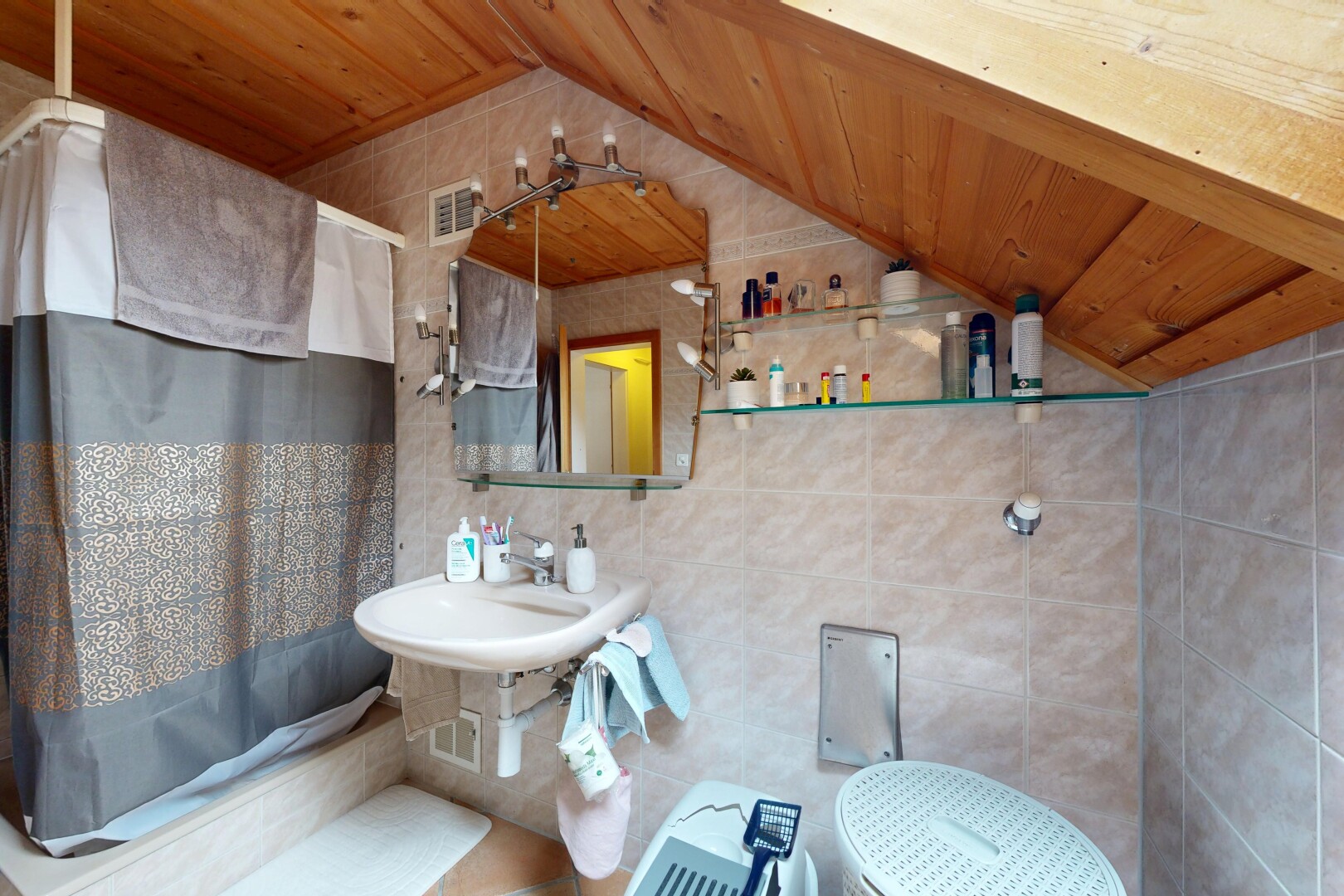 bathroom with tile walls, a vaulted wooden ceiling, tiled shower / bath combo, and decorative backsplash