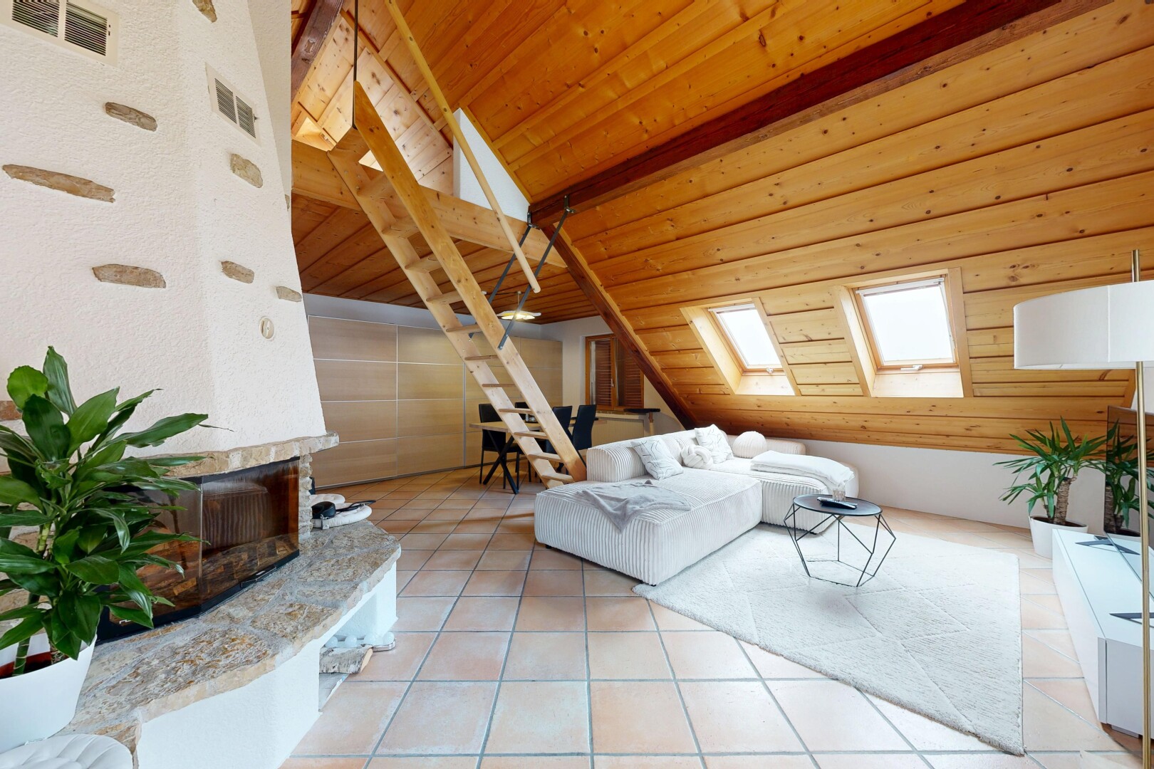 living area with a skylight, a high end fireplace, lofted ceiling with beams, light tile patterned flooring, and wooden ceiling