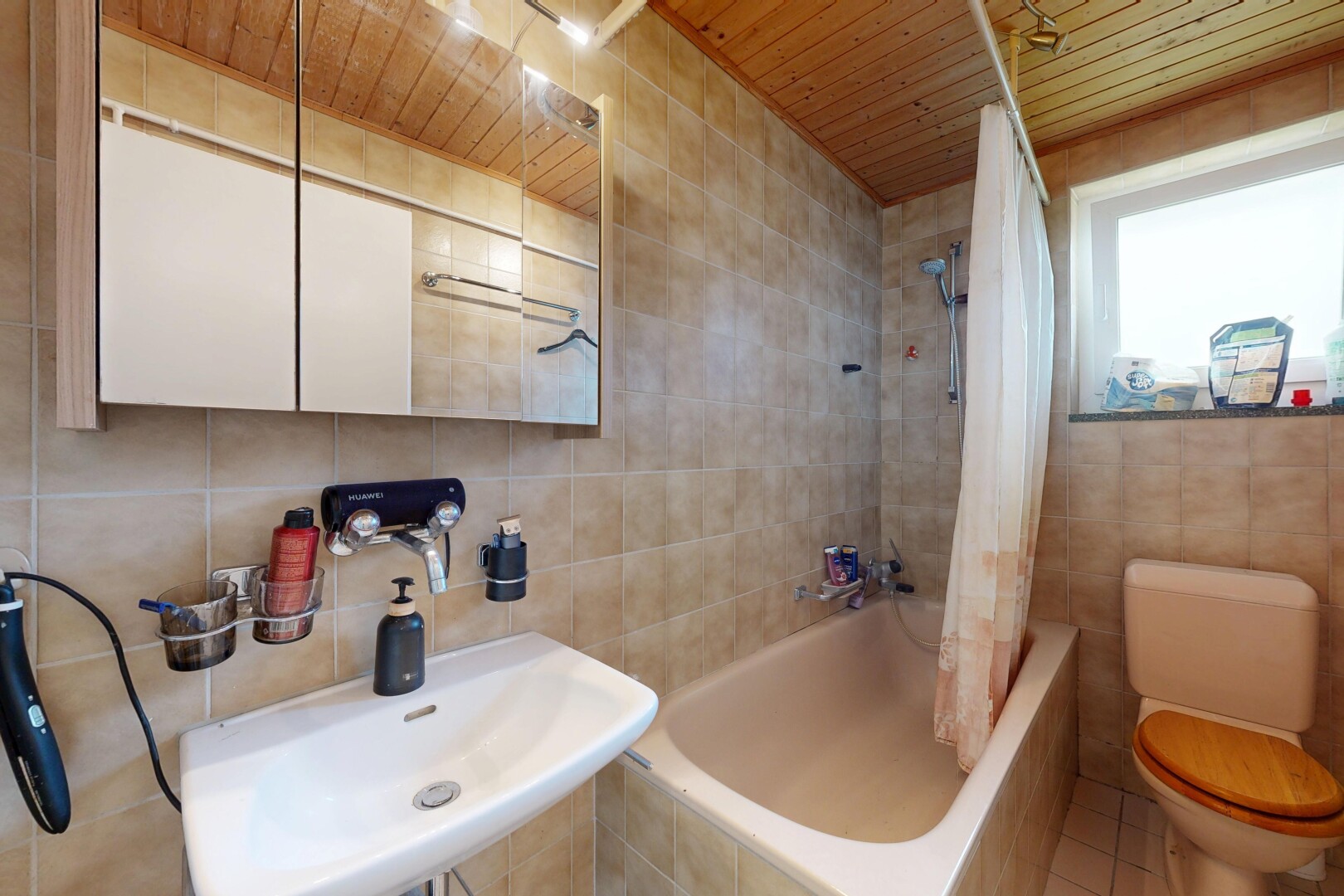 full bathroom featuring tile walls, tiled shower / bath combo, and wood ceiling