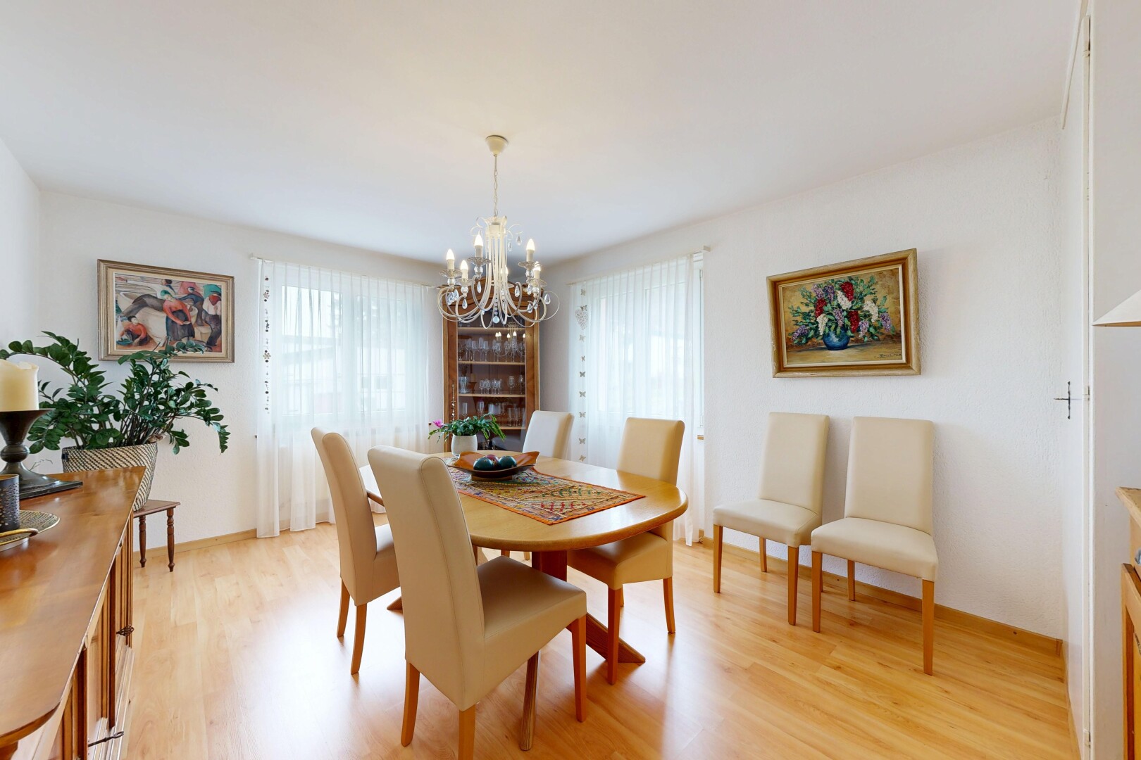 dining room featuring light wood-type flooring, plenty of natural light, and hanging lights