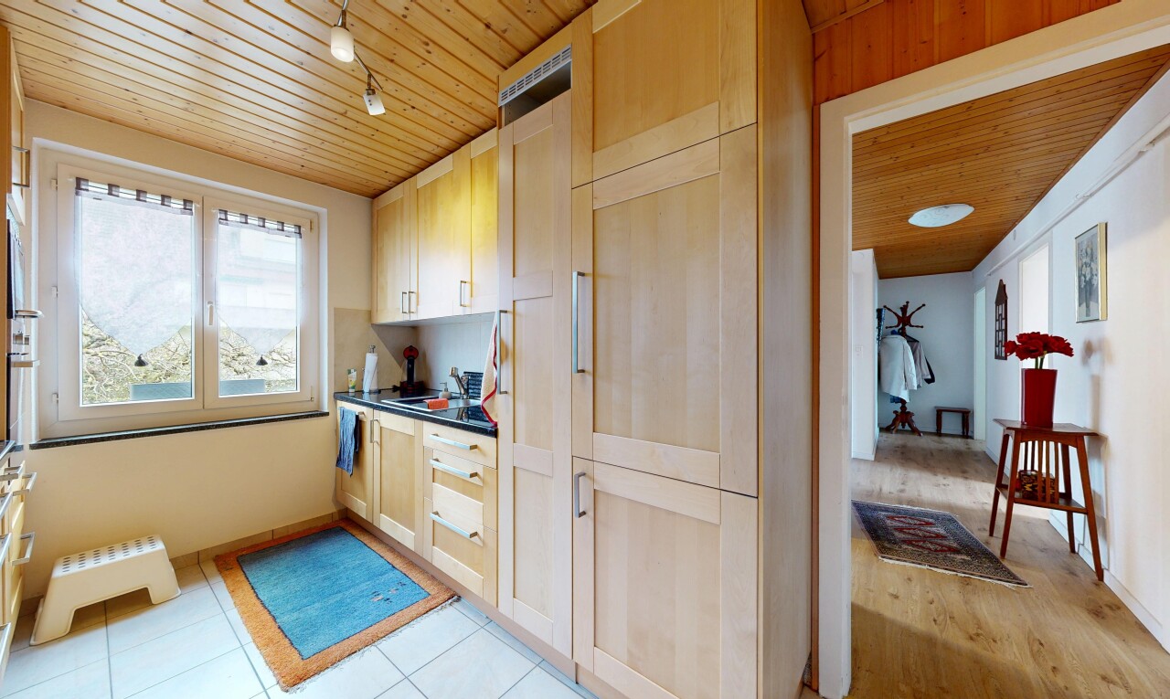 kitchen with wood ceiling, dark countertops, and light wood finish cabinetry
