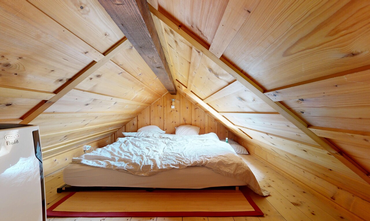 room featuring wooden ceiling, wood walls, and light wood-style flooring