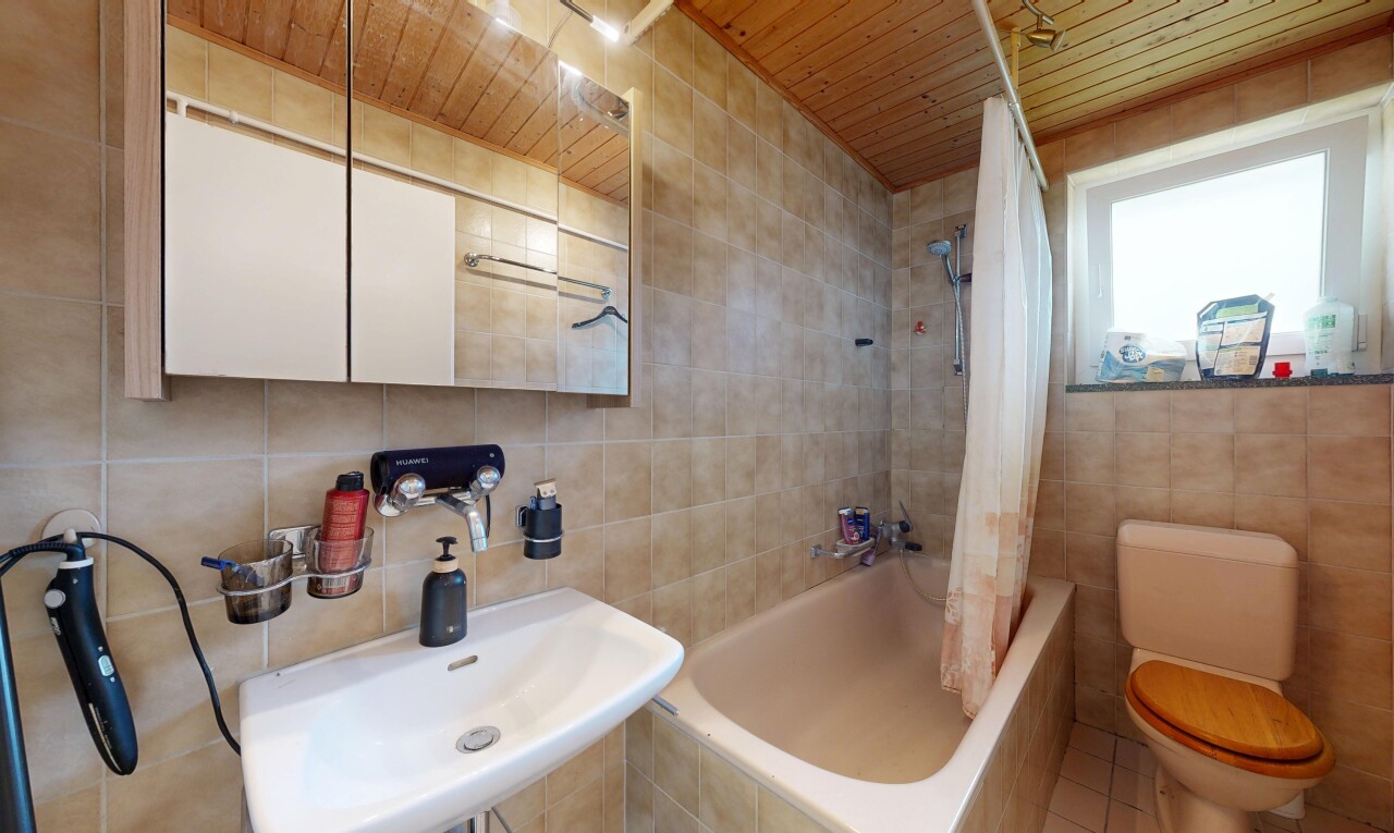 full bathroom featuring tile walls, tiled shower / bath combo, and wood ceiling