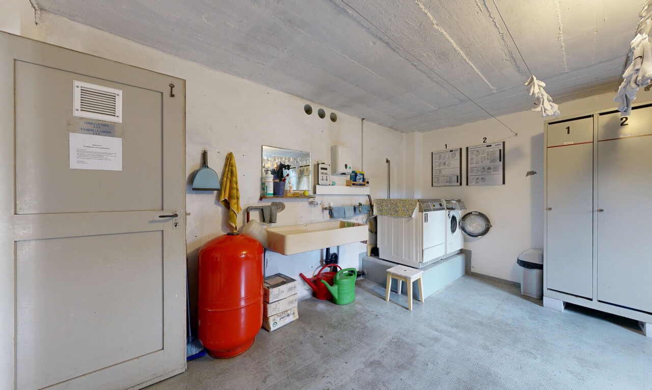 kitchen featuring unfinished concrete flooring and washer and clothes dryer