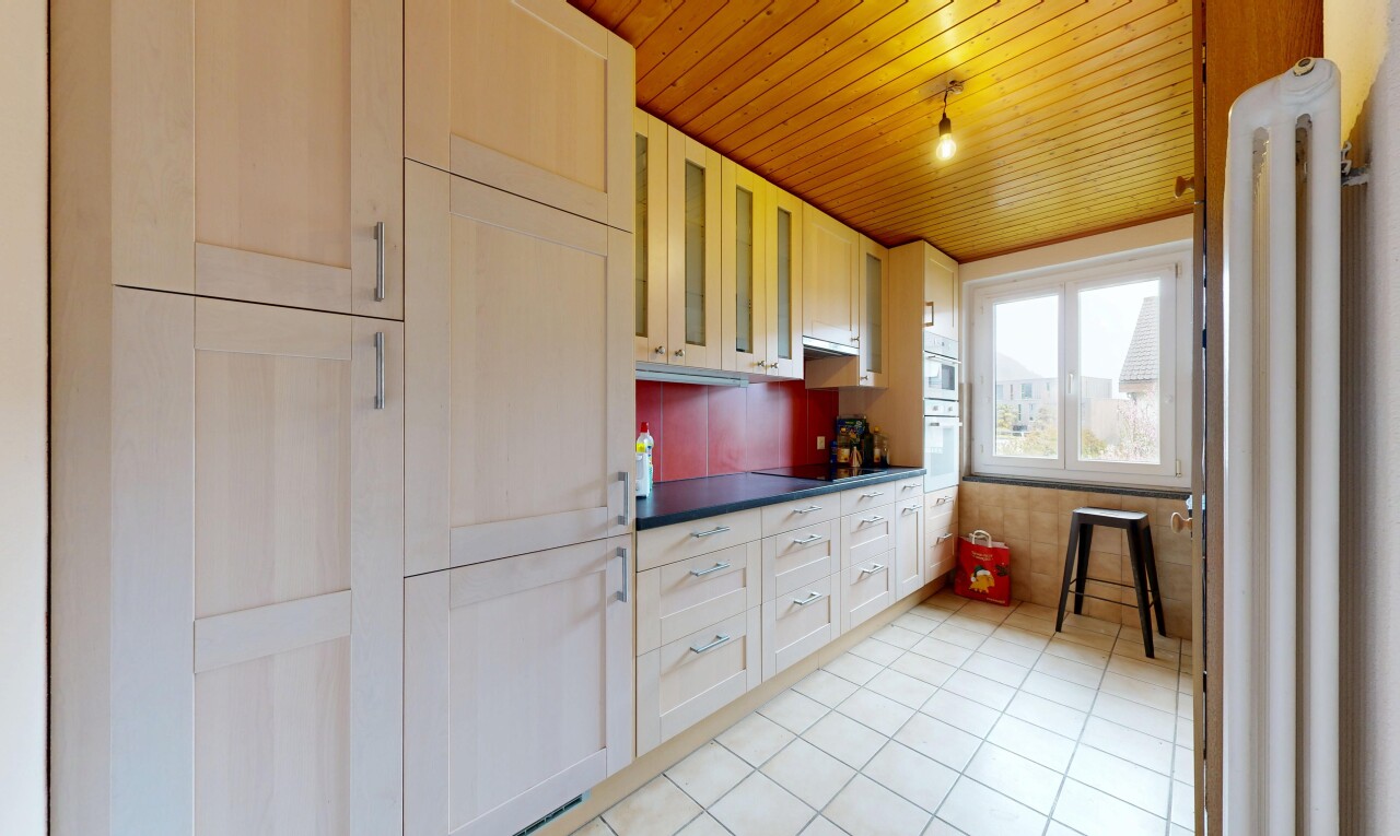 kitchen featuring dark countertops, wood ceiling, glass insert cabinets, light tile patterned floors, and black electric stovetop