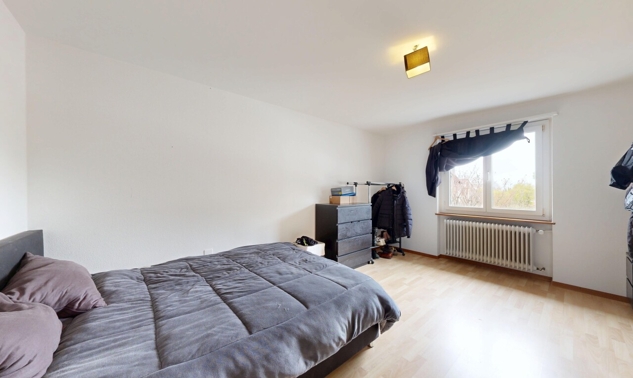room / bedroom with radiator and light wood-type flooring