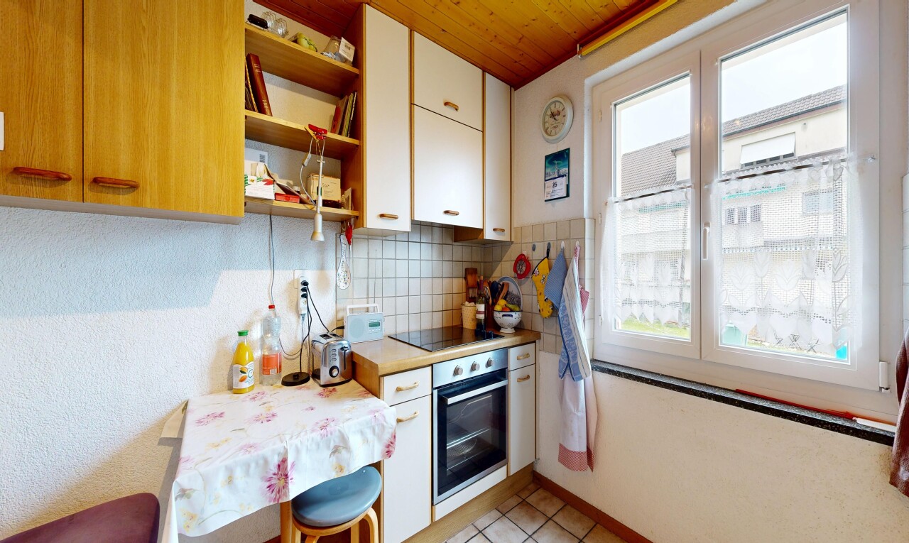 kitchen featuring light countertops, white cabinets, open shelves, backsplash, and stainless steel oven