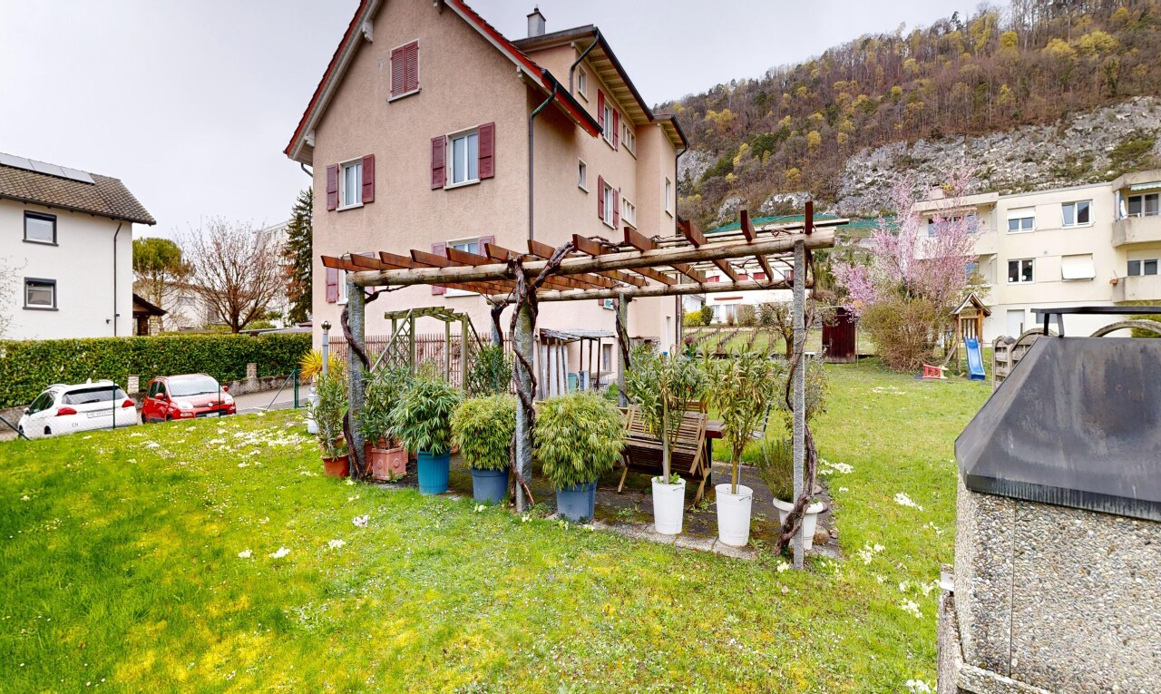garden with a pergola and a lawn