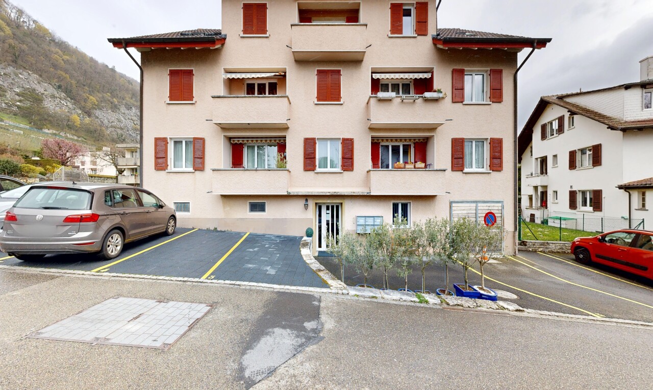 view of property featuring uncovered parking