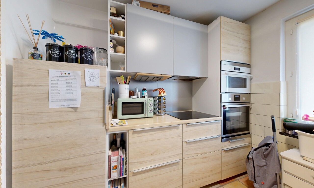 kitchen with white microwave, open shelves, stainless steel double oven, light countertops, and black electric stovetop