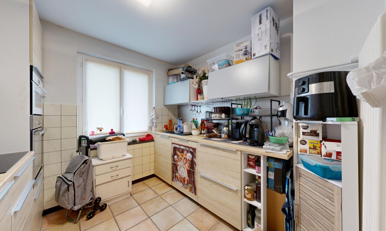 kitchen with light countertops, light tile patterned floors, and open shelves
