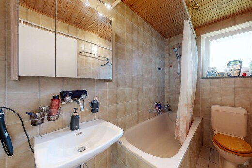 full bathroom featuring tile walls, tiled shower / bath combo, and wood ceiling
