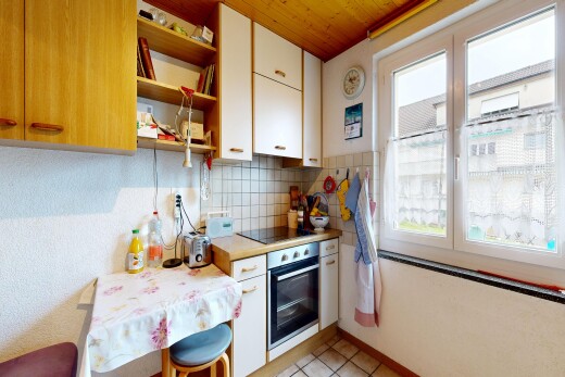 kitchen featuring light countertops, white cabinets, open shelves, backsplash, and stainless steel oven