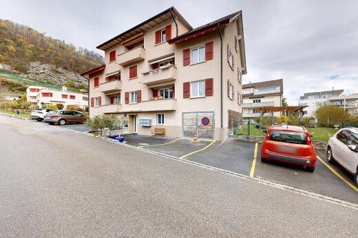 view of building exterior featuring uncovered parking