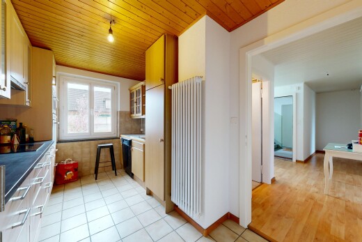 kitchen with radiator, wooden ceiling, glass insert cabinets, light tile patterned floors, and black electric stovetop