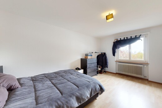 room / bedroom with radiator and light wood-type flooring