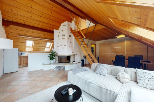 living room featuring a glass covered fireplace, light tile patterned flooring, wooden ceiling, wood walls, and a skylight
