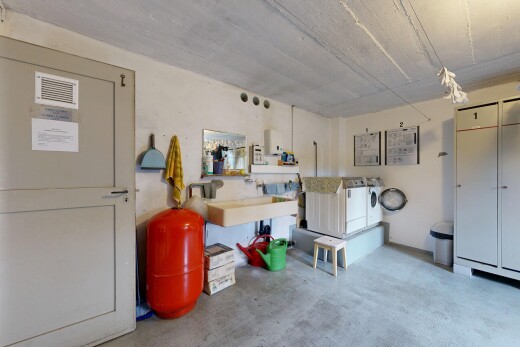 kitchen featuring unfinished concrete flooring and washer and clothes dryer