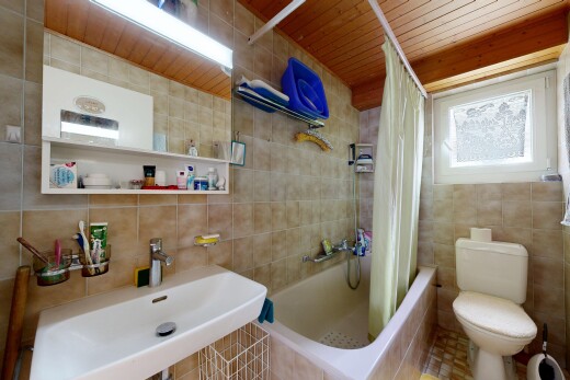 full bath with tile walls, tiled shower / bath combo, and wood ceiling