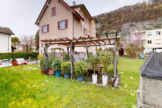 garden with a pergola and a lawn