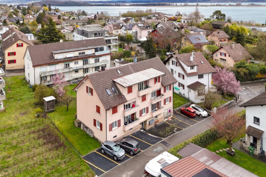 outdoor house with uncovered parking, a water view, and a residential view