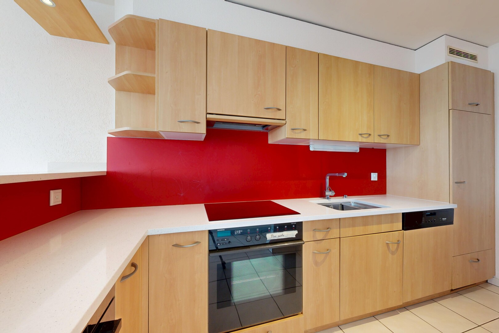 cuisine avec light brown cabinets, armoires marron clair, four, light countertops, et open shelves