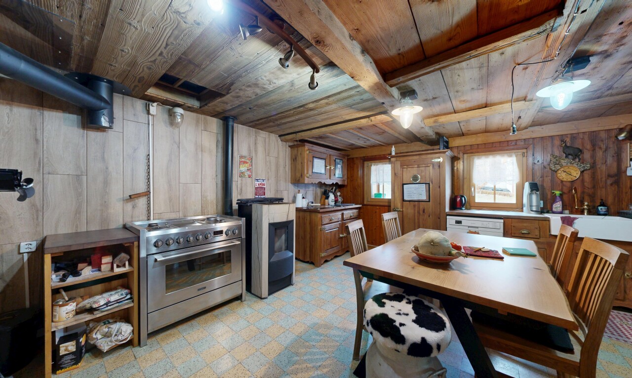 salle à manger avec mur en bois, wood wall, plafond en bois, wood ceiling, et sol en vinyle