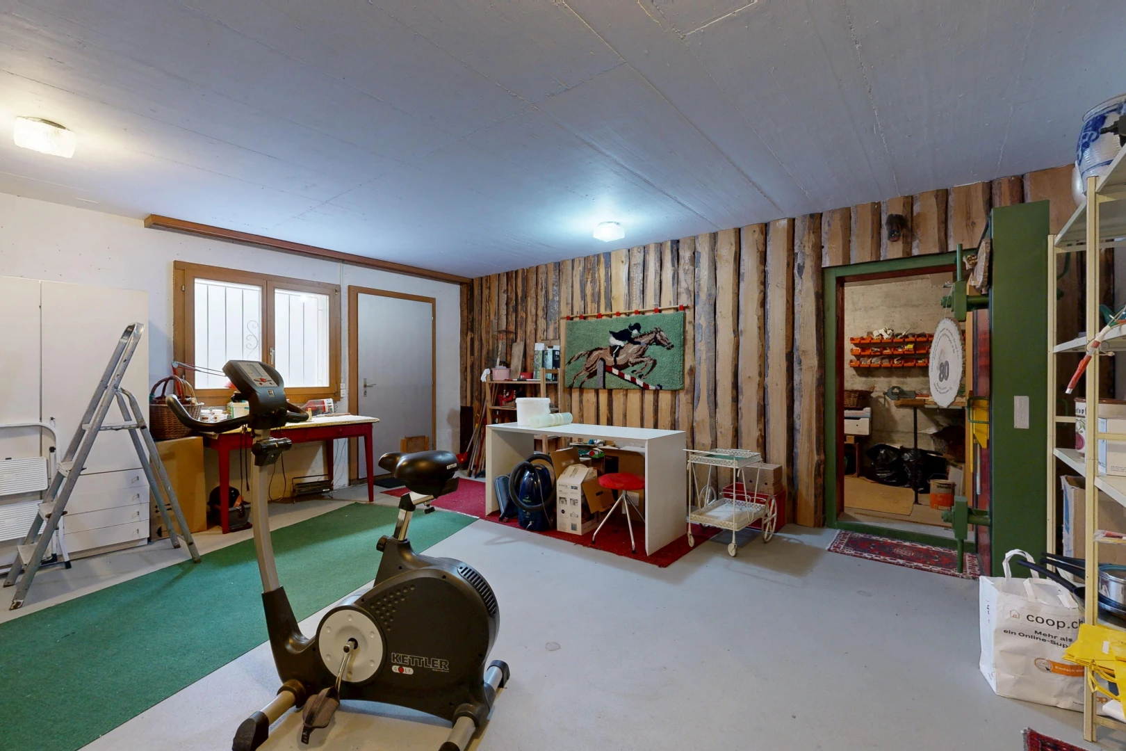workout area featuring wooden walls and concrete flooring