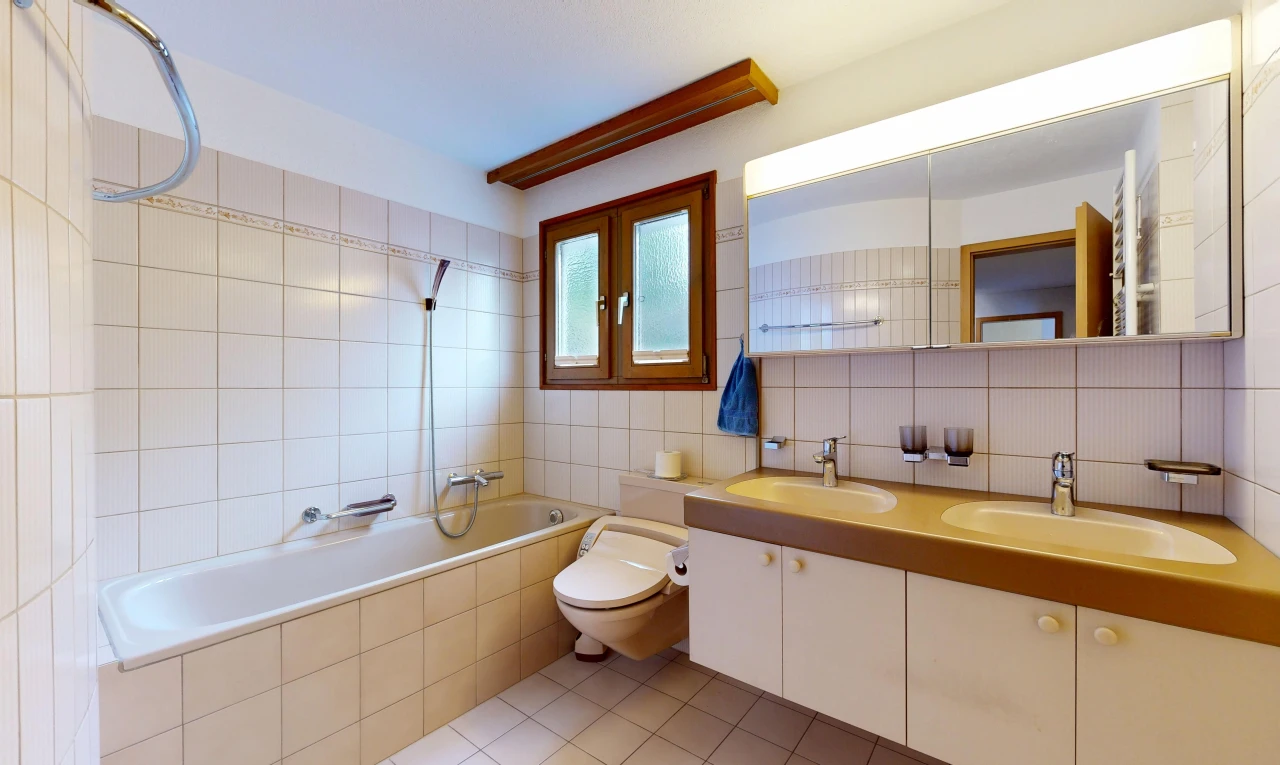 bathroom with tasteful backsplash, light tile patterned floors, tiled shower / bath, double vanity, and tile walls