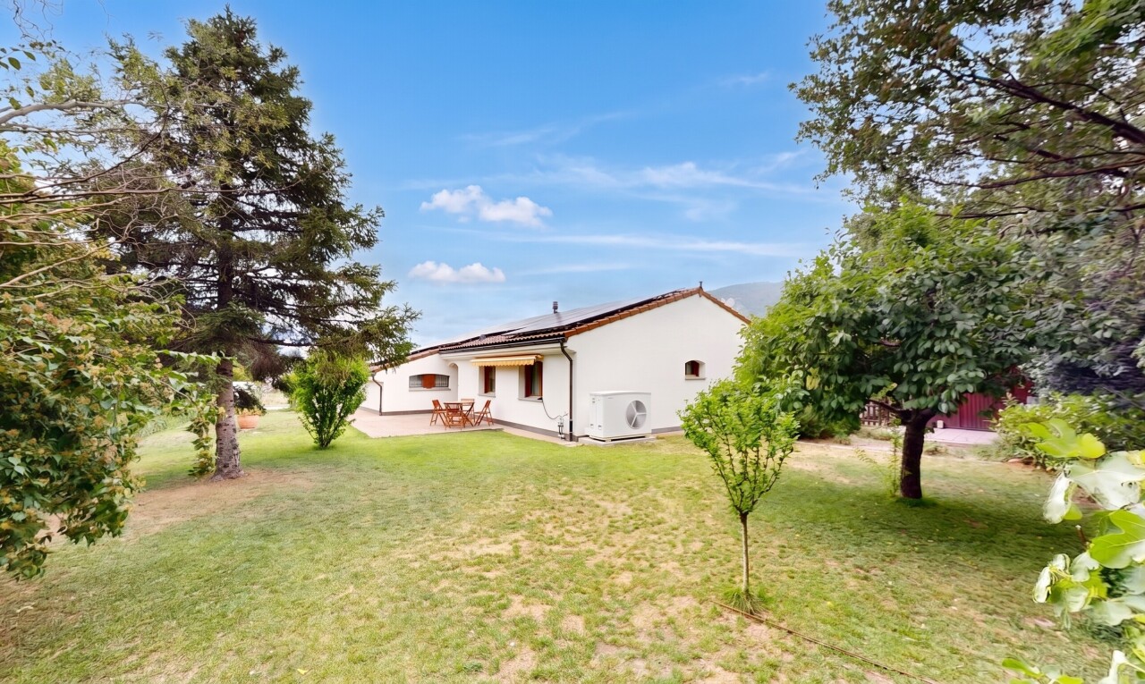 façade avec property visible, pelouse, panneaux solaires, day time, et bardage en stuc