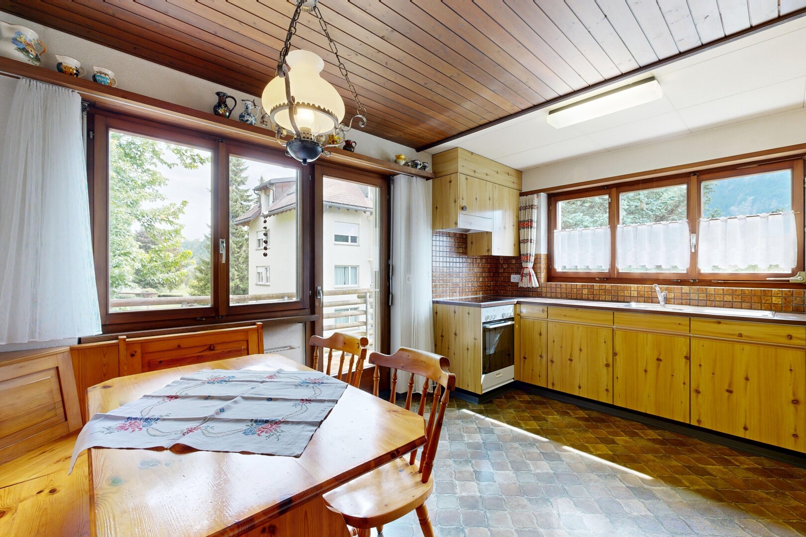 kitchen featuring wooden ceiling, tasteful backsplash, oven, pendant lighting, and light countertops