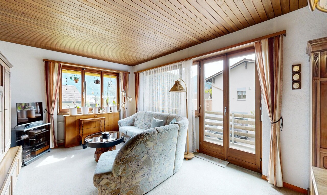 living room with wood ceiling and carpet floors