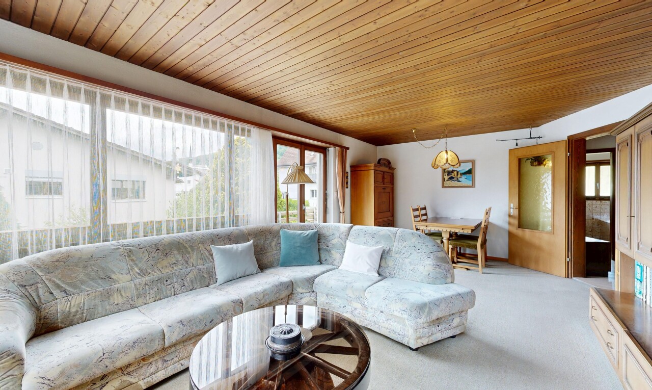 living area with wood ceiling and carpet flooring