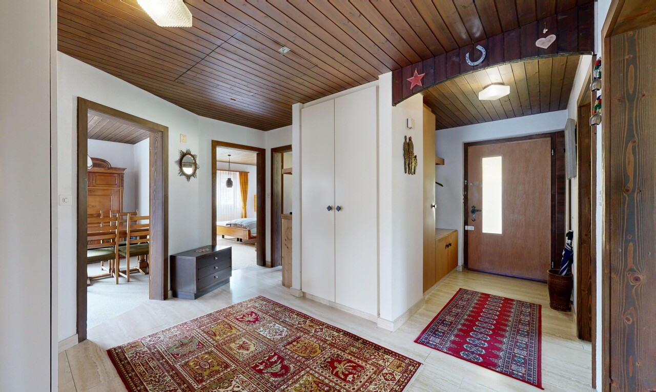 hall with wooden ceiling and light wood-style flooring