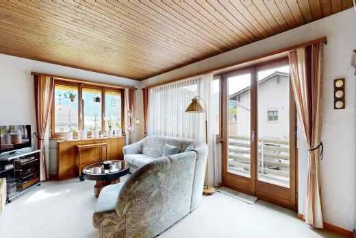 living room with wood ceiling and carpet floors
