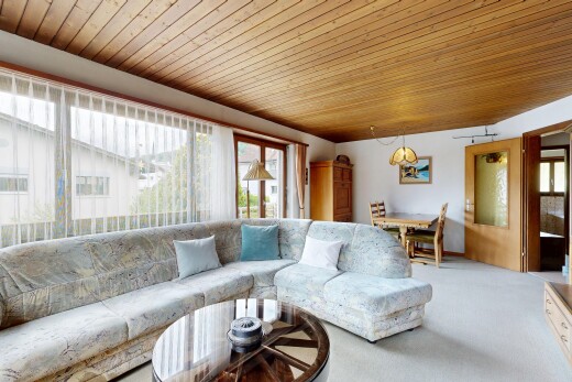 living area with wood ceiling and carpet flooring