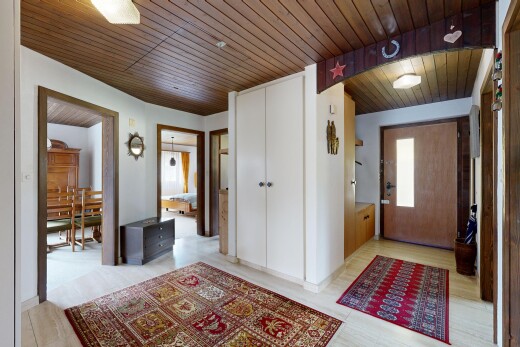 hall with wooden ceiling and light wood-style flooring