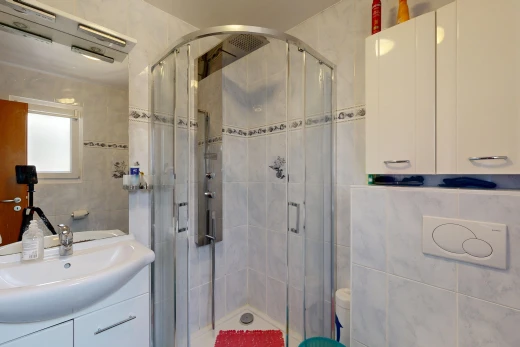 salle de bains avec tile wall, mur en carrelage, salle de bain complète, douche, et lavabo (ou coiffeuse selon le contexte)