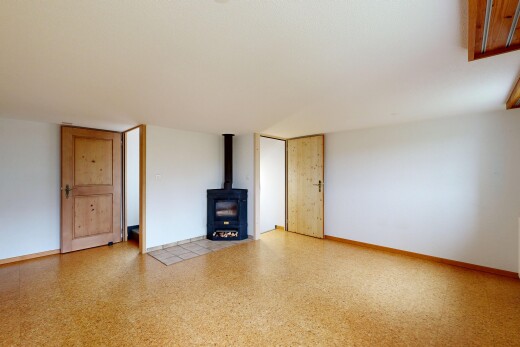 pièce vide avec poêle à bois, drywall, cloison sèche, inside property, et baseboards wall
