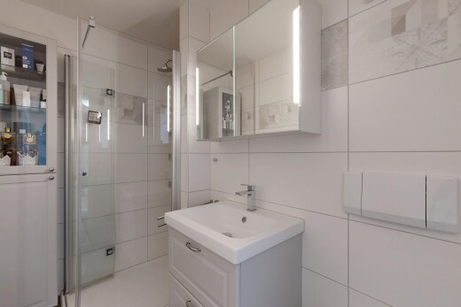 salle de bains avec lavabo (ou coiffeuse selon le contexte), miroir, tile wall, mur en carrelage, et salle de bain complète