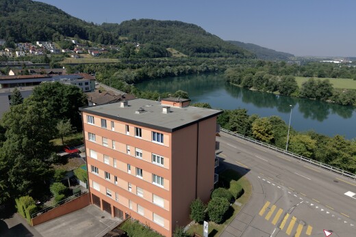 view of mountain backdrop with a large body of water and a heavily wooded area