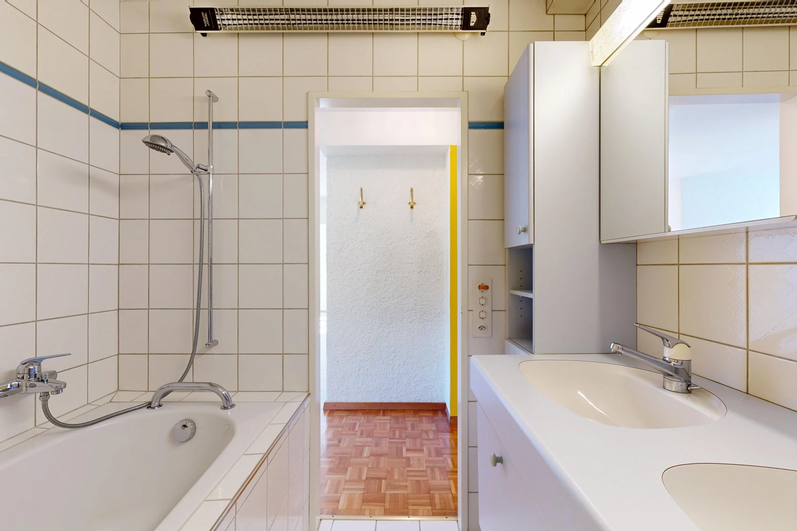 salle de bains avec salle de bain complète, douche-bain combinés, évier, miroir, et double vasque