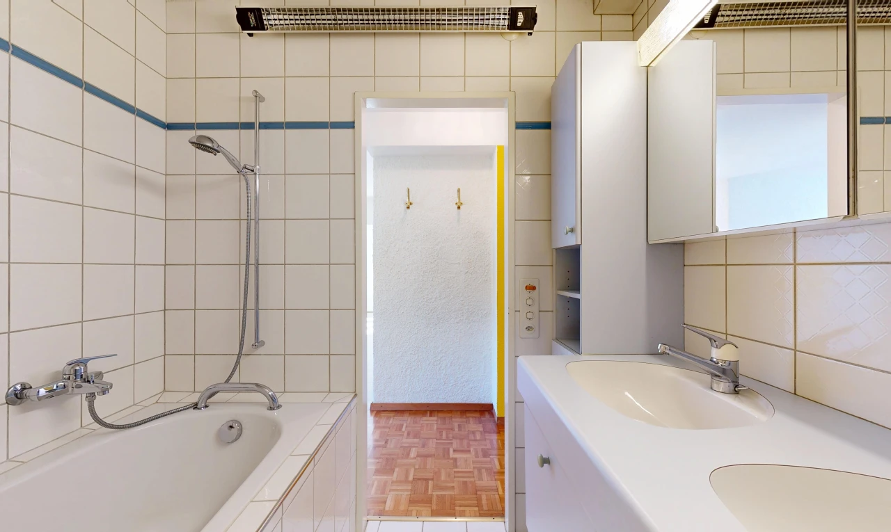 salle de bains avec salle de bain complète, douche-bain combinés, évier, miroir, et double vasque