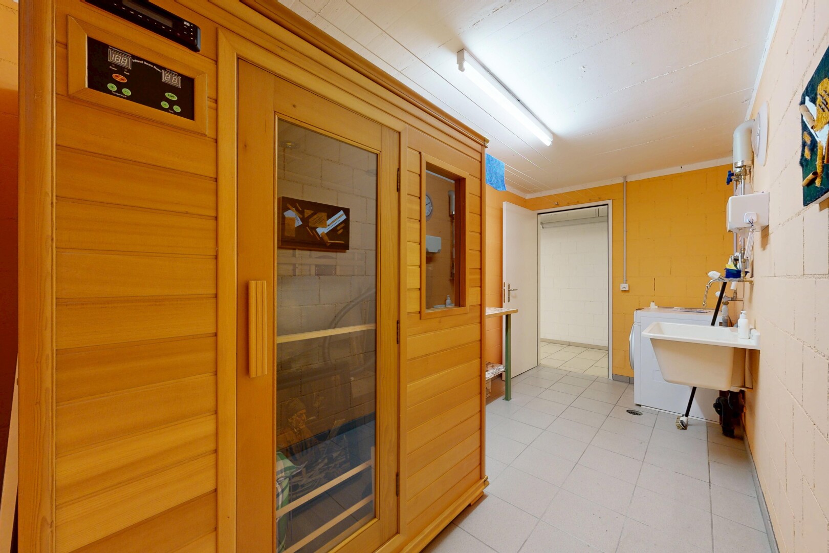 interior space featuring a relaxing sauna, ornamental molding, and washer / dryer
