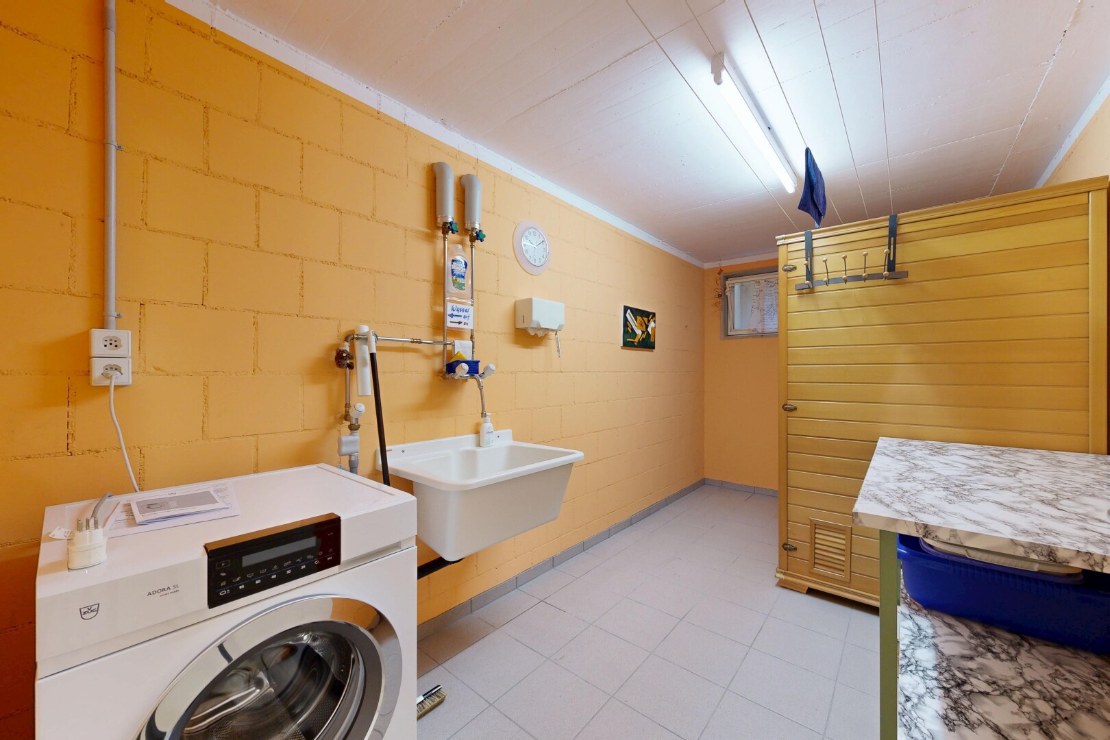 laundry area featuring washer / clothes dryer and concrete block wall