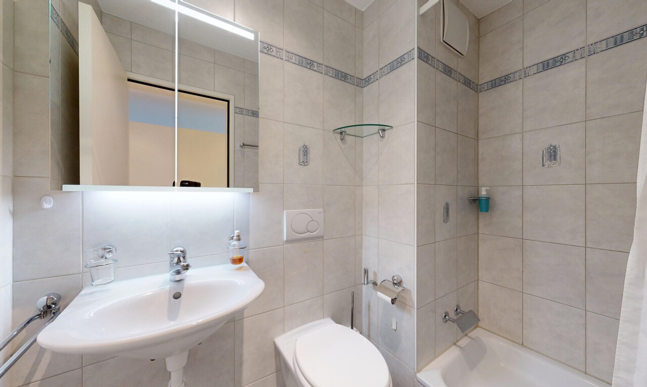 bathroom featuring tile walls and tub / shower combination