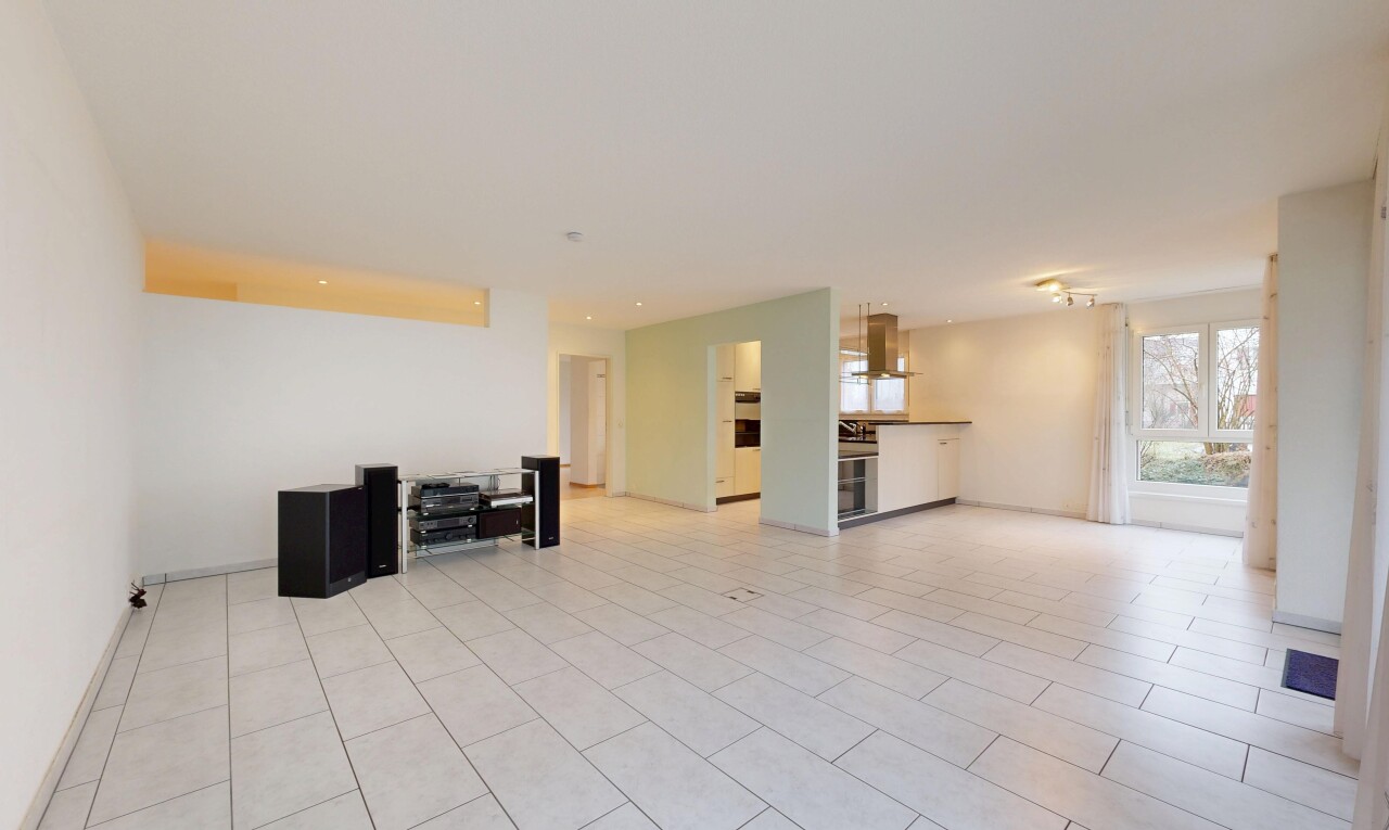 unfurnished living room with baseboards